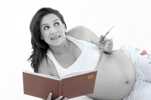 Pregnant woman with a journal